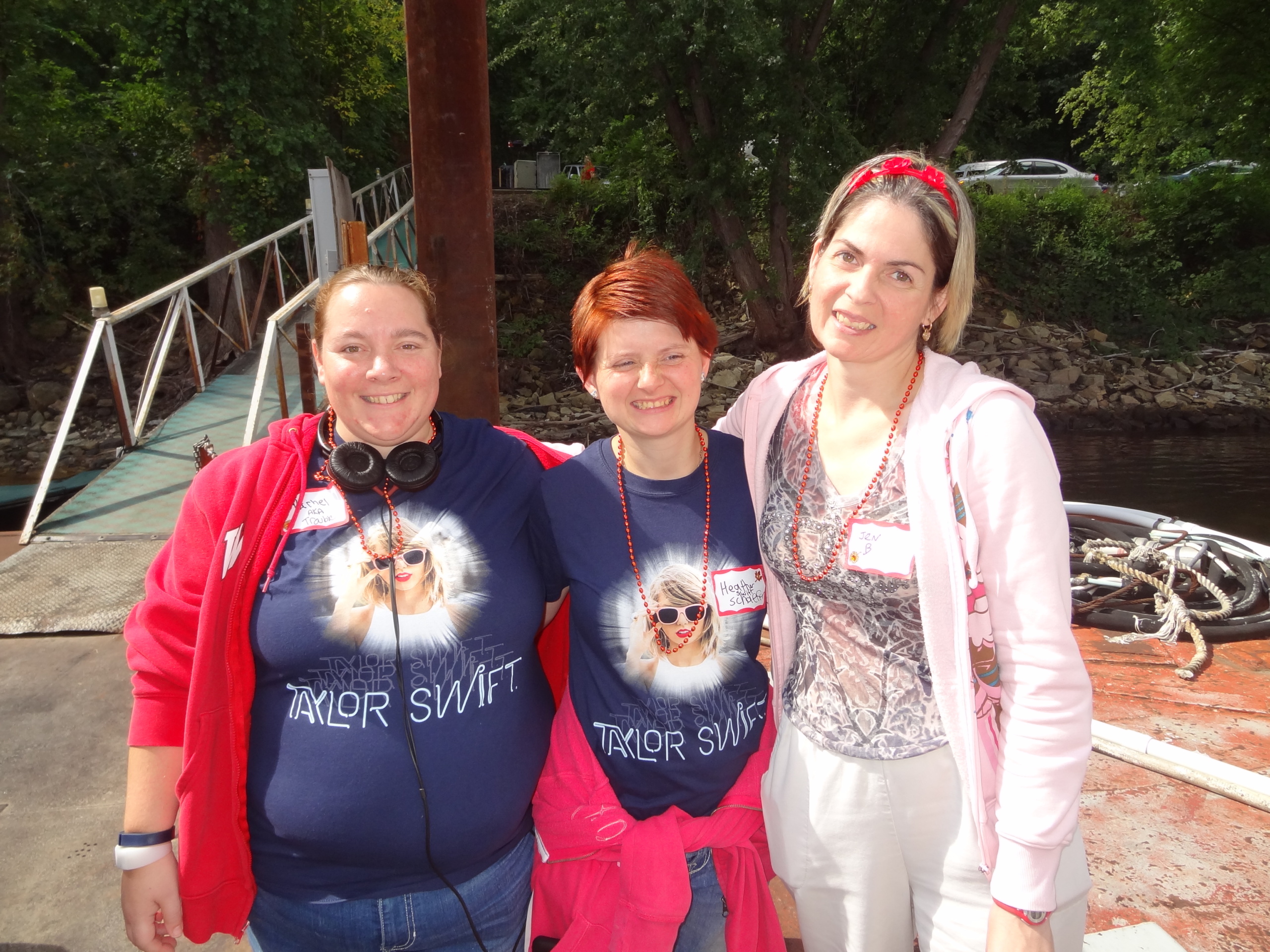 group of 3 individuals smiling for a photo in Taylor Swift shirts